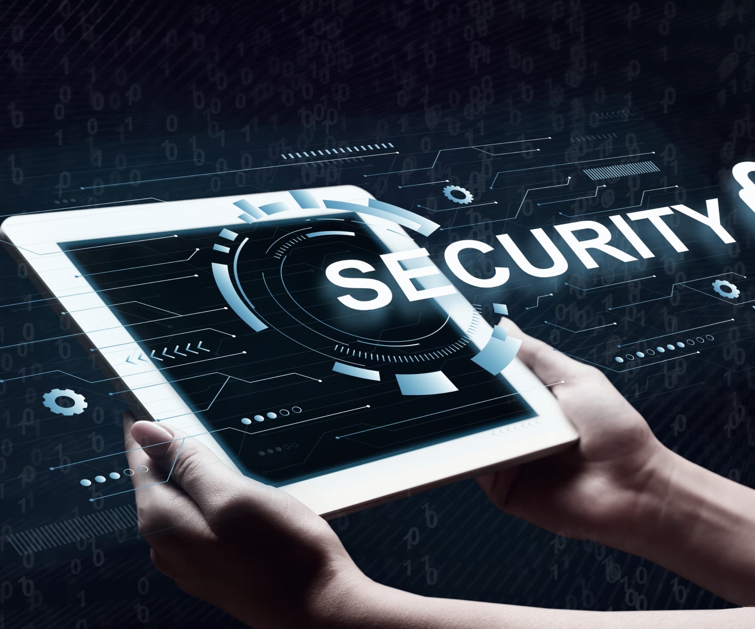 A hand holding a tablet displaying a security lock and cyber interface.